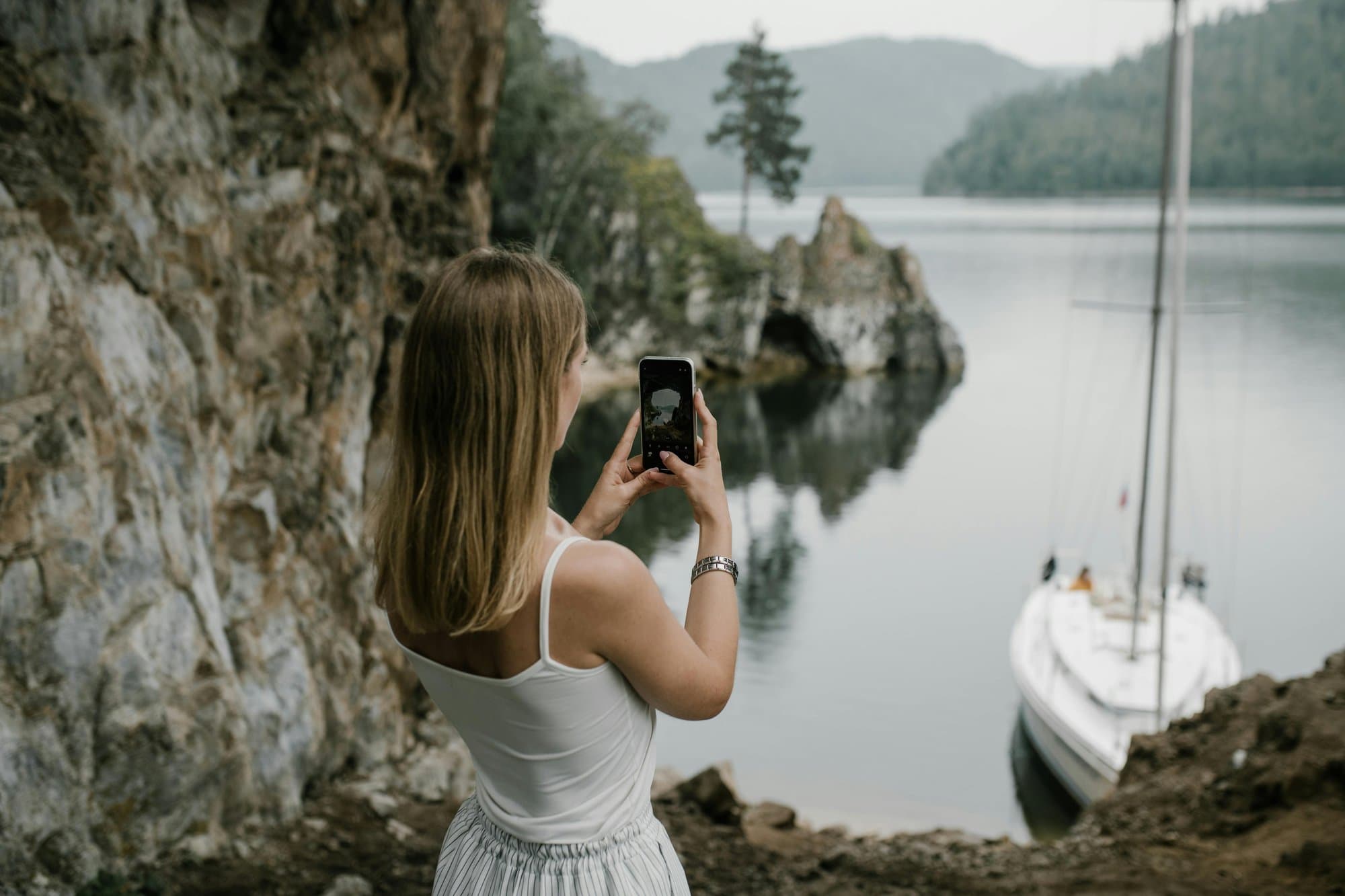 Traveler capturing a quiet lakeside destination